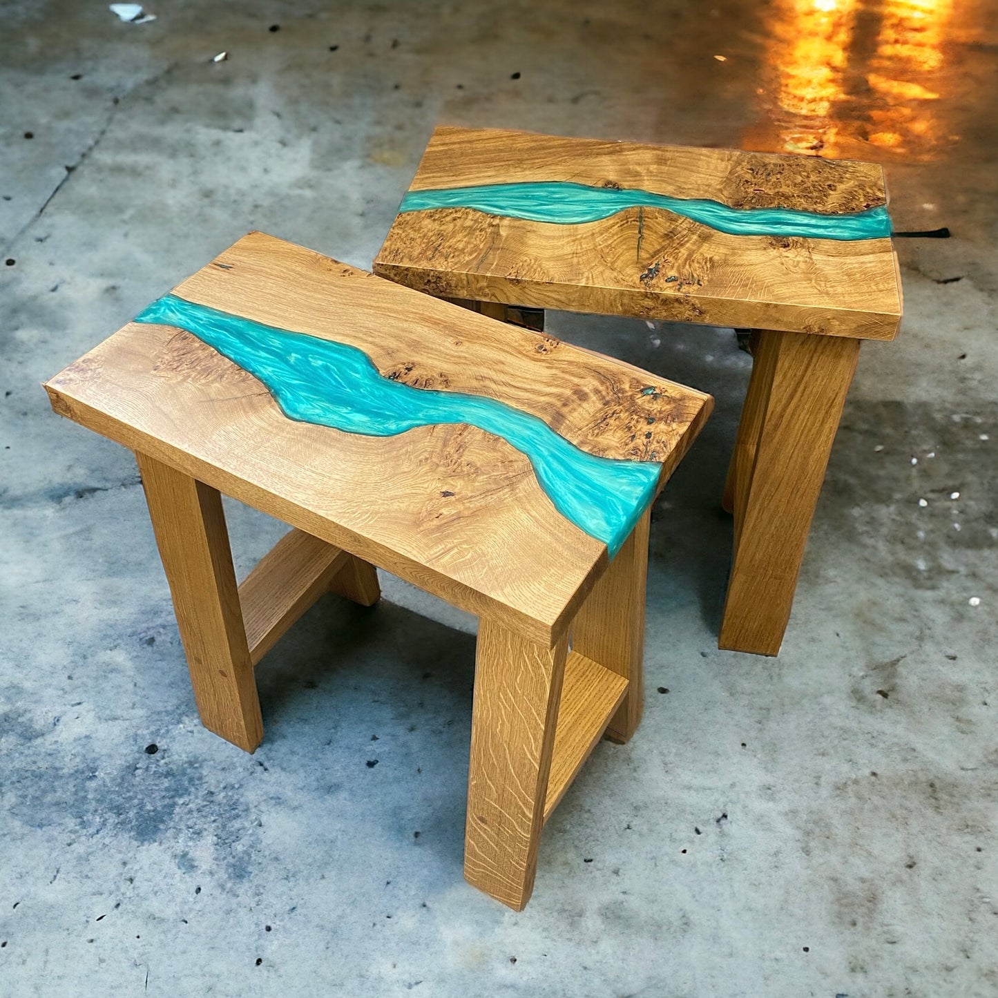 A pair of solid oak and epoxy resin rectangle end tables. featuring a teal resin river running the full length of the table tops and supported by custom made solid oak a frame legs
