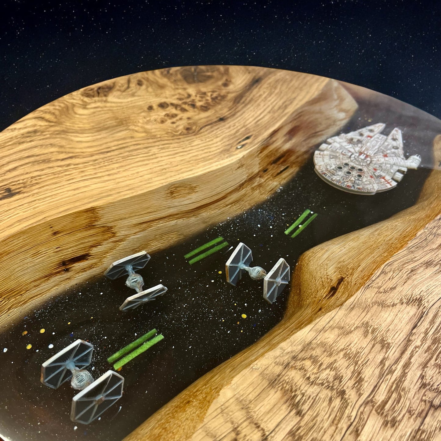 Close-up of the Star Wars-themed epoxy resin design, showcasing detailed X-Fighters and the Millennium Falcon in a swirling galaxy effect.