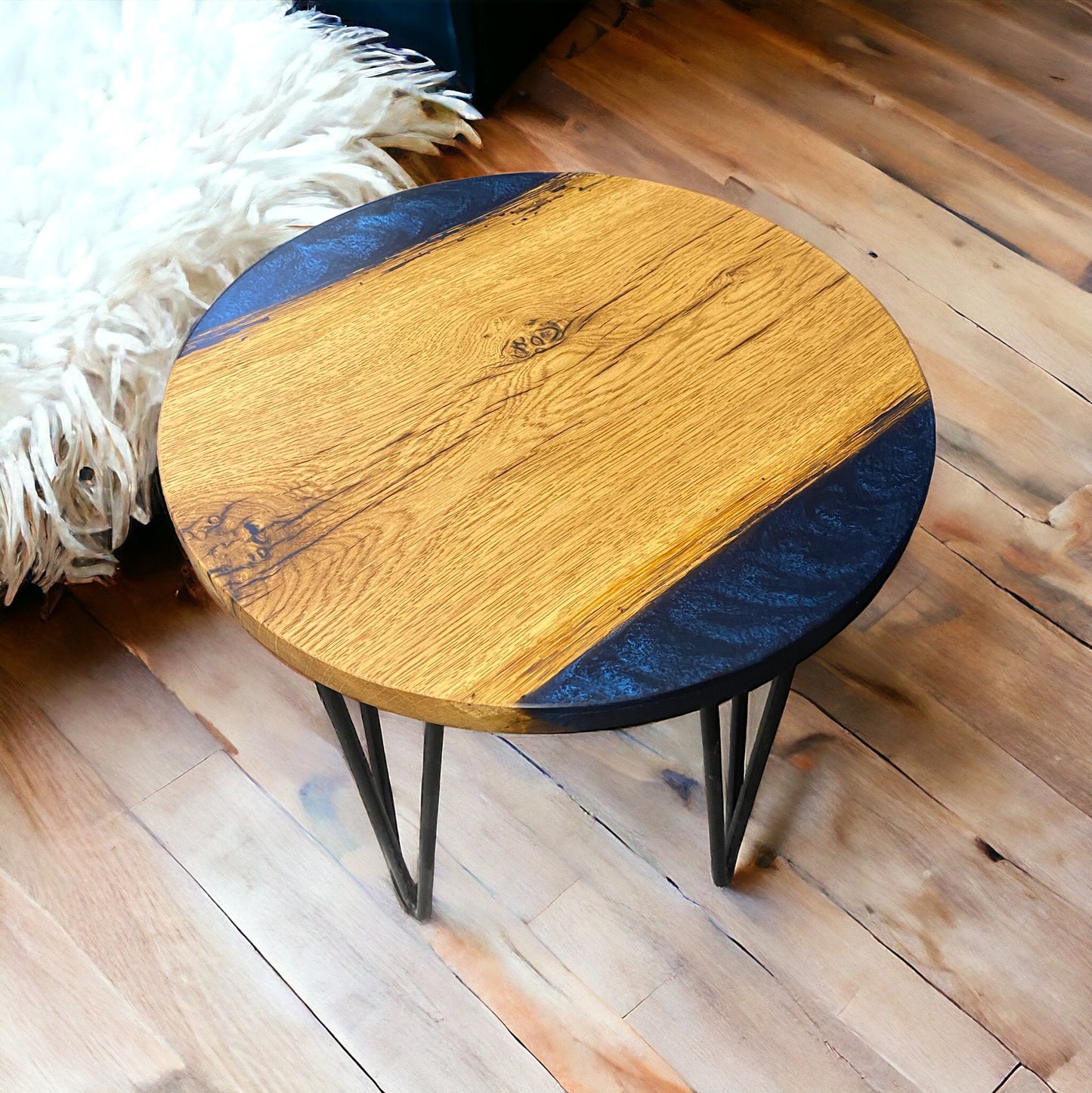 A handmade oak and navy blue epoxy resin end table with sleek black hairpin legs, offering a modern yet timeless design.