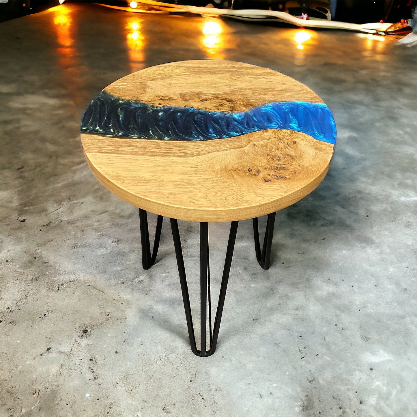 Handmade oak and resin end table with sleek black hairpin legs, showcasing a vibrant peacock-toned resin design