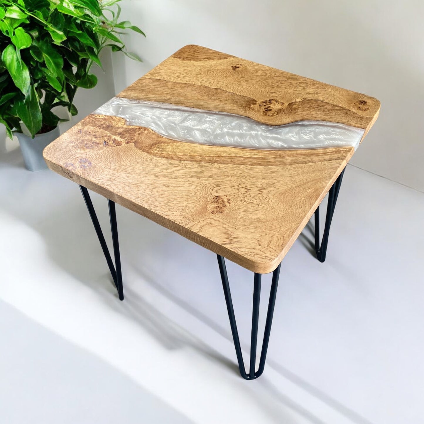 Right-side view of the oak and white epoxy end table, displaying the modern design and seamless wood-to-resin transition.