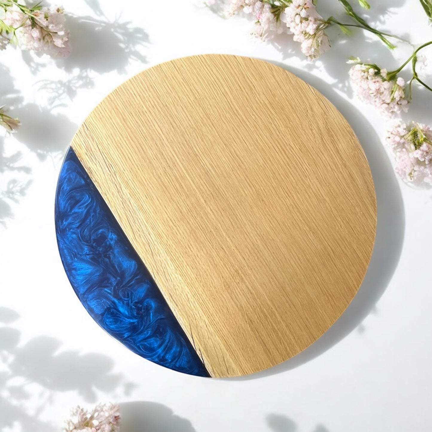 A perspective shot of the table, emphasizing the contrast between the natural oak and striking blue resin edge.
