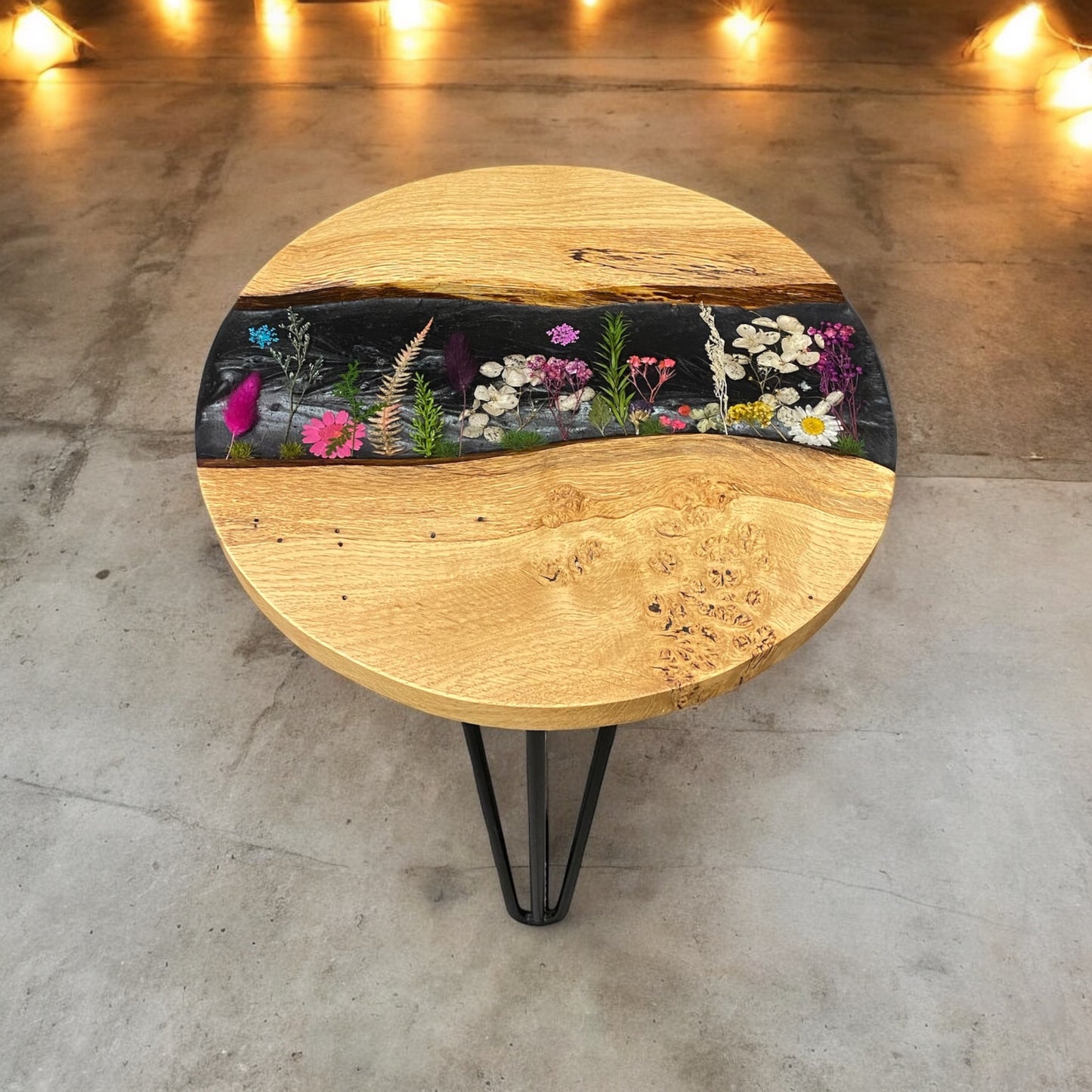 Front-facing view of the oak and resin end table, showcasing the contrast between the natural wood grain and the intricate black floral pattern.