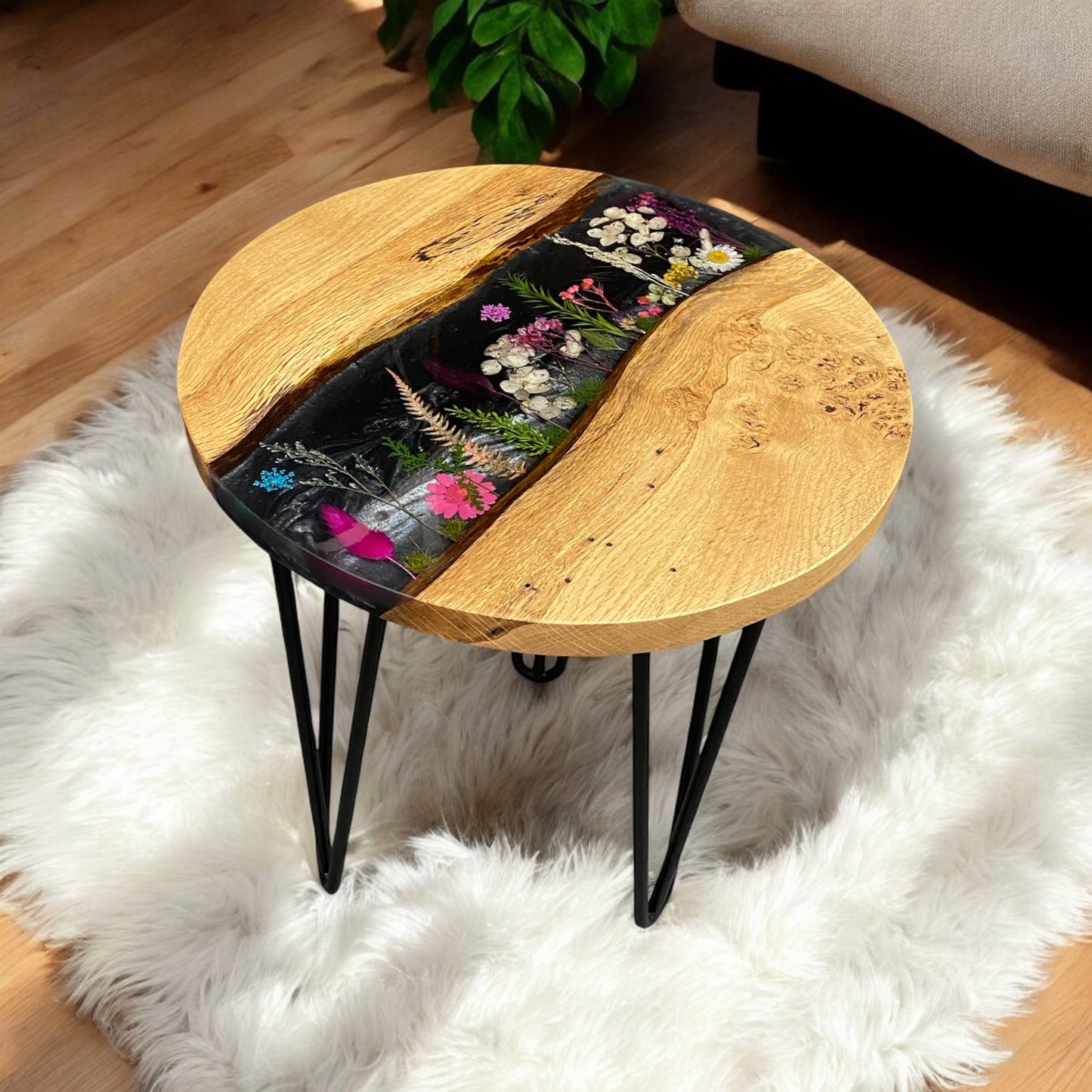 Right-side angle of the black floral epoxy resin end table, highlighting the smooth resin finish and solid oak construction.