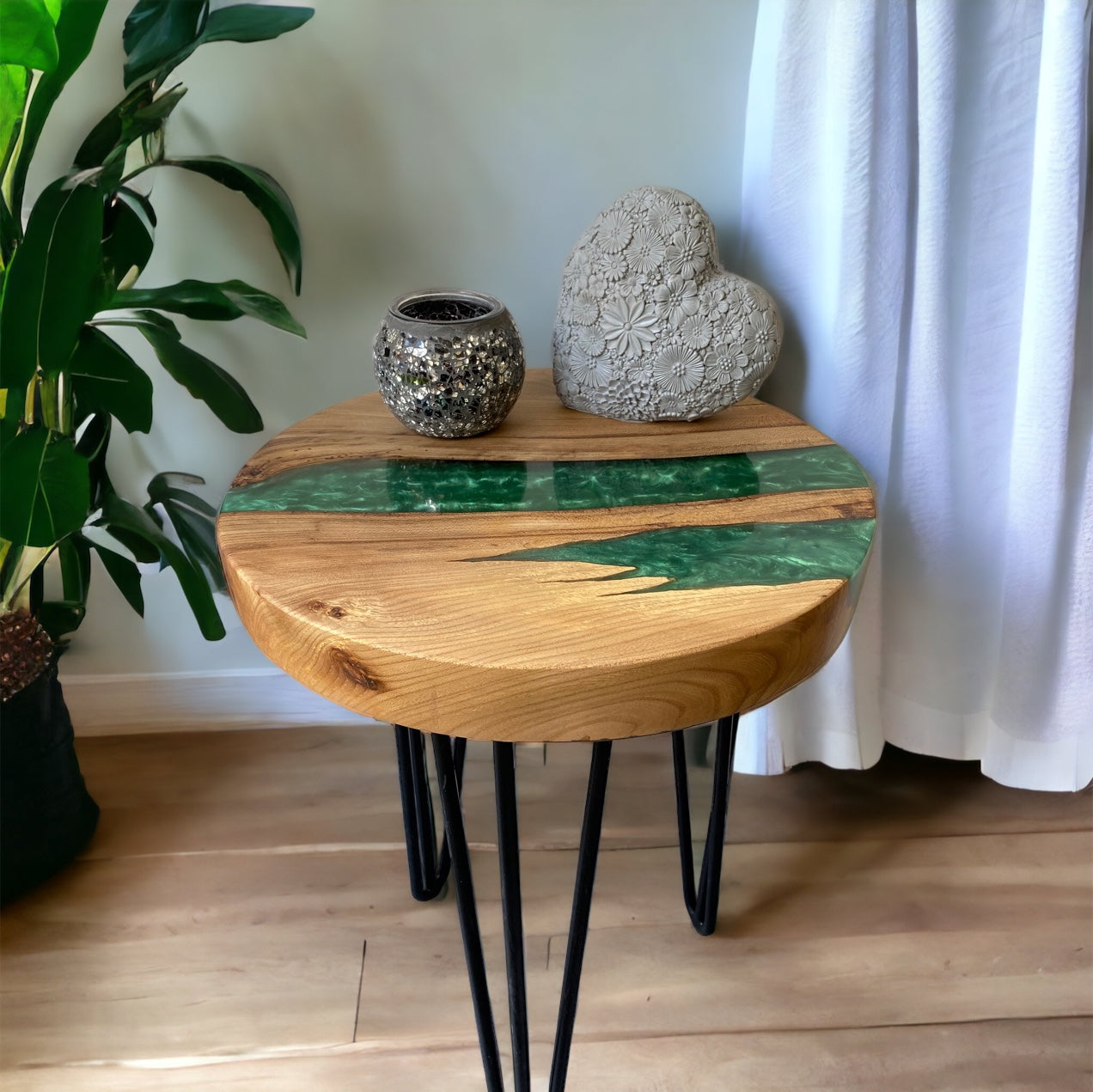 Stylish oak and forest green epoxy resin end table with sleek black hairpin legs, blending organic wood patterns with a rich, glossy resin finish.