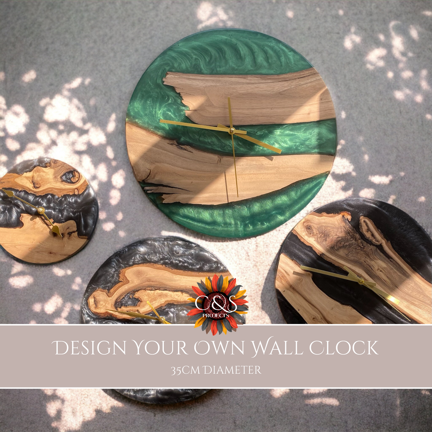 A collection of four handcrafted epoxy resin and oak wall clocks displayed on a light surface with dappled sunlight.
