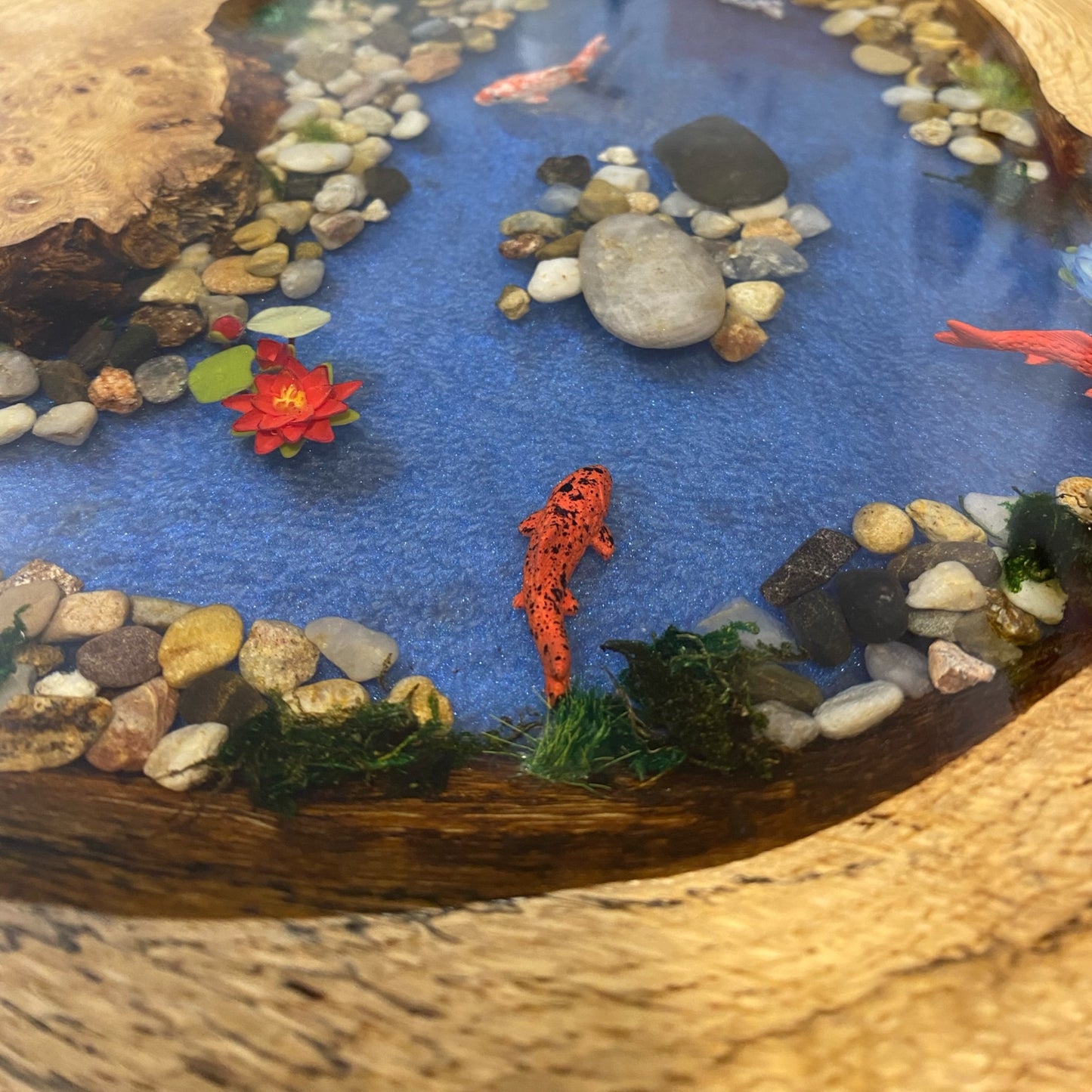 Close-up view of koi pond resin table focusing on the realistic koi fish, adding depth and movement to the table's surface.