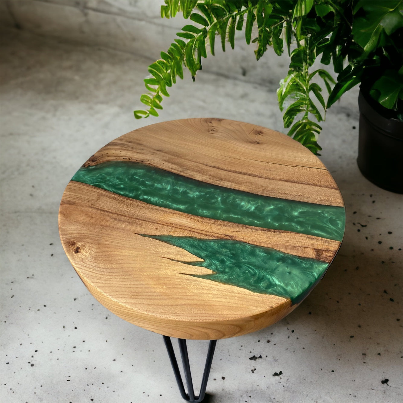 A handcrafted oak and forest green epoxy resin end table, showcasing a stunning river of deep green resin against natural oak grain.