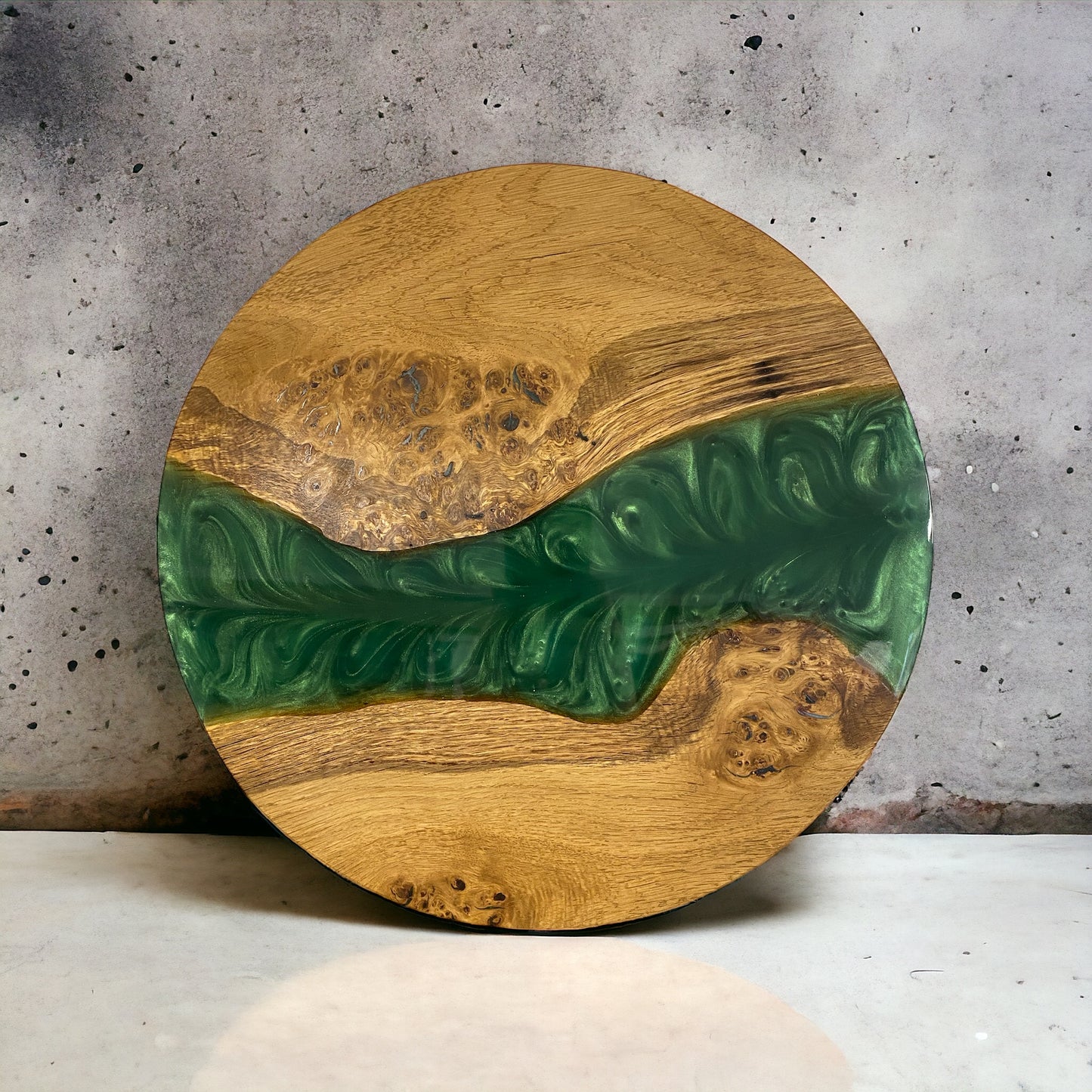 a round oak and green resin disk, used for clock faces, table tops and centrepieces. the resin features a swirling leaf style pattern.