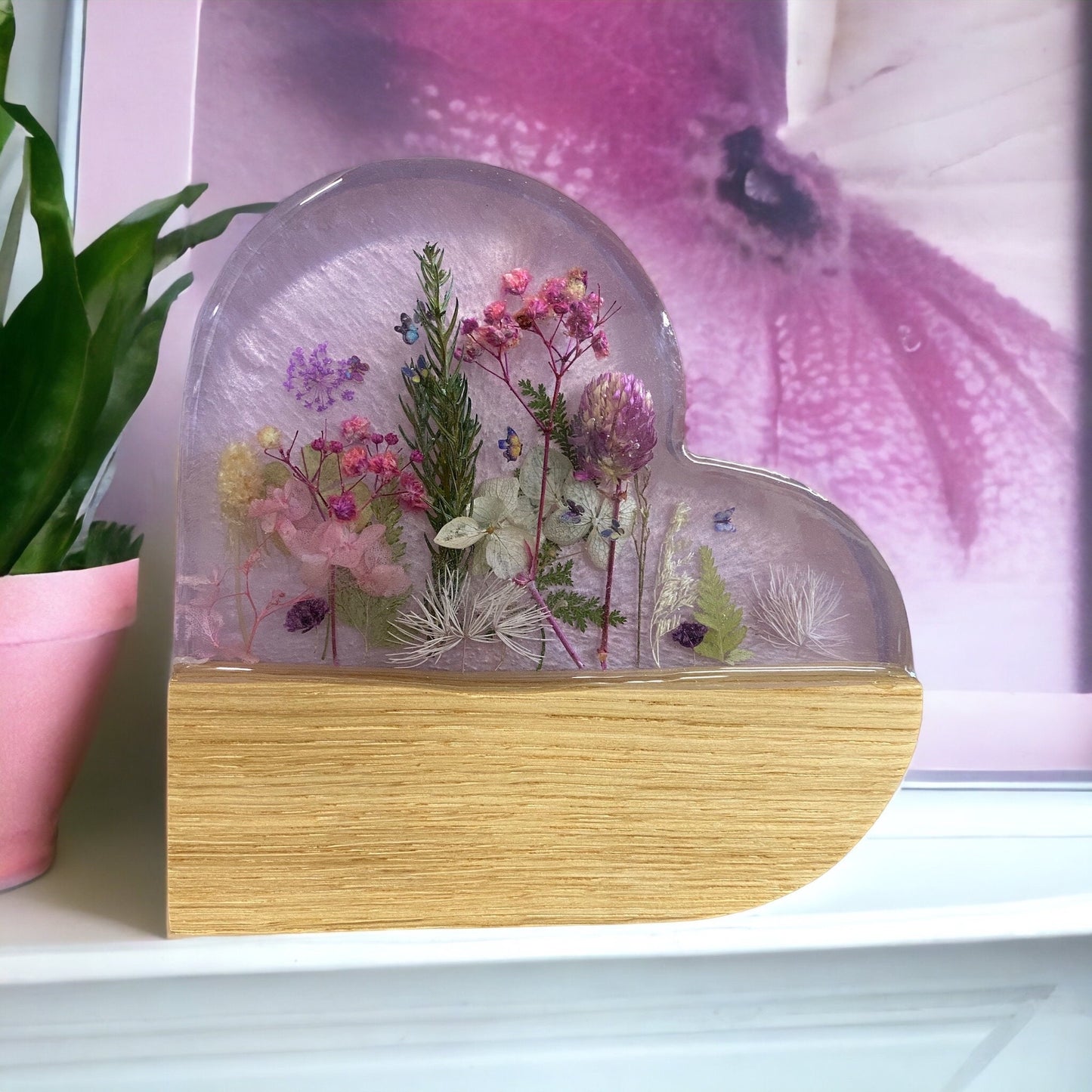 A beautiful purple resin and oak heart shaped ornament, with real dried flowers inlayed into a clear resin.