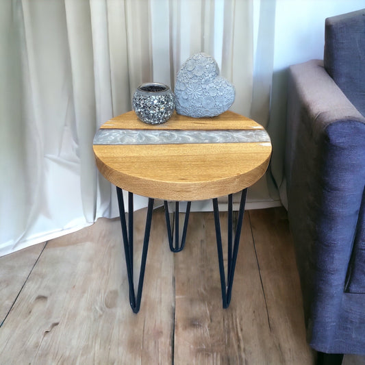 A handcrafted oak and pearl white epoxy resin end table, featuring a sleek, modern design with elegant black hairpin legs.