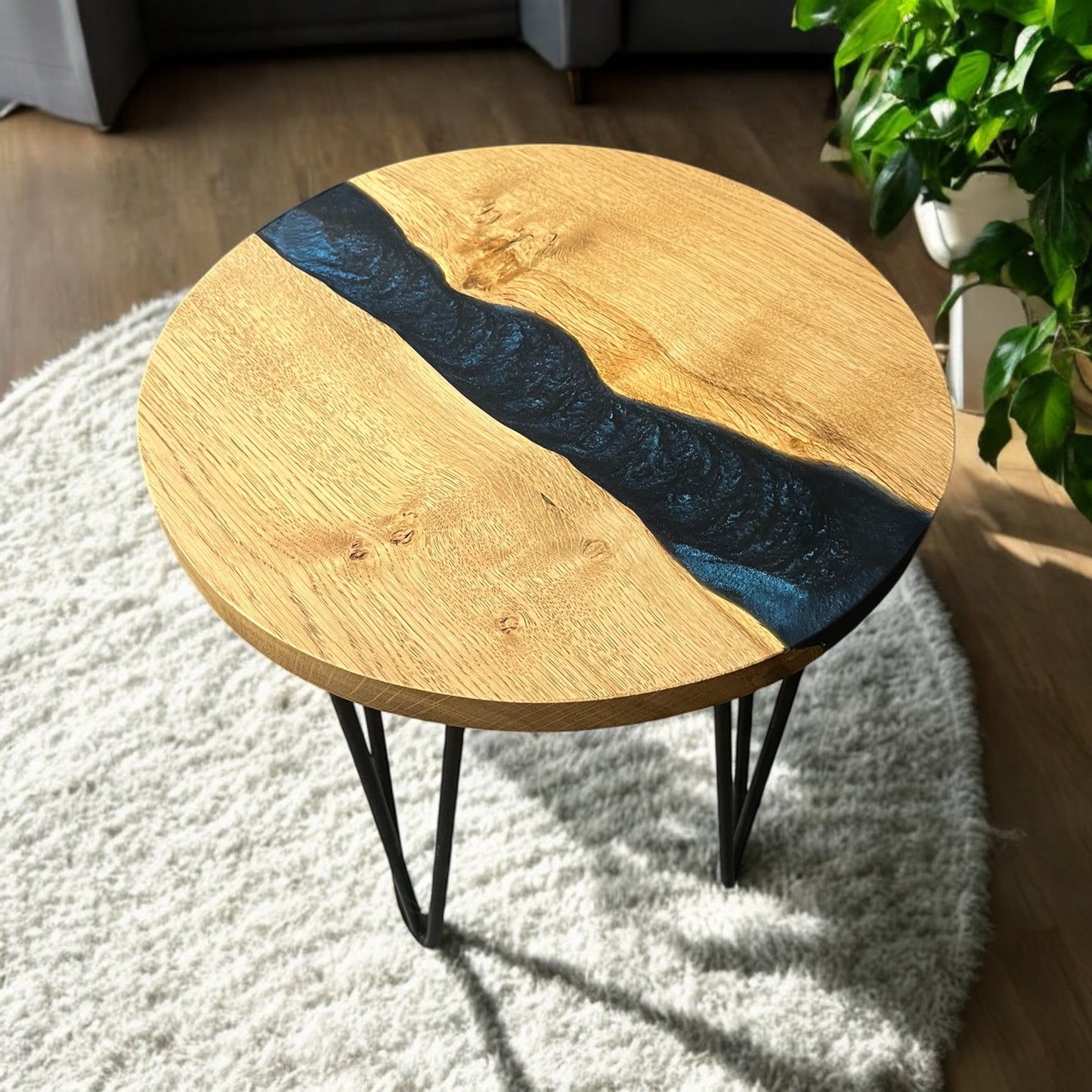 Right-side angle of the handcrafted oak end table, highlighting the swirling blue resin that mimics the depths of space.