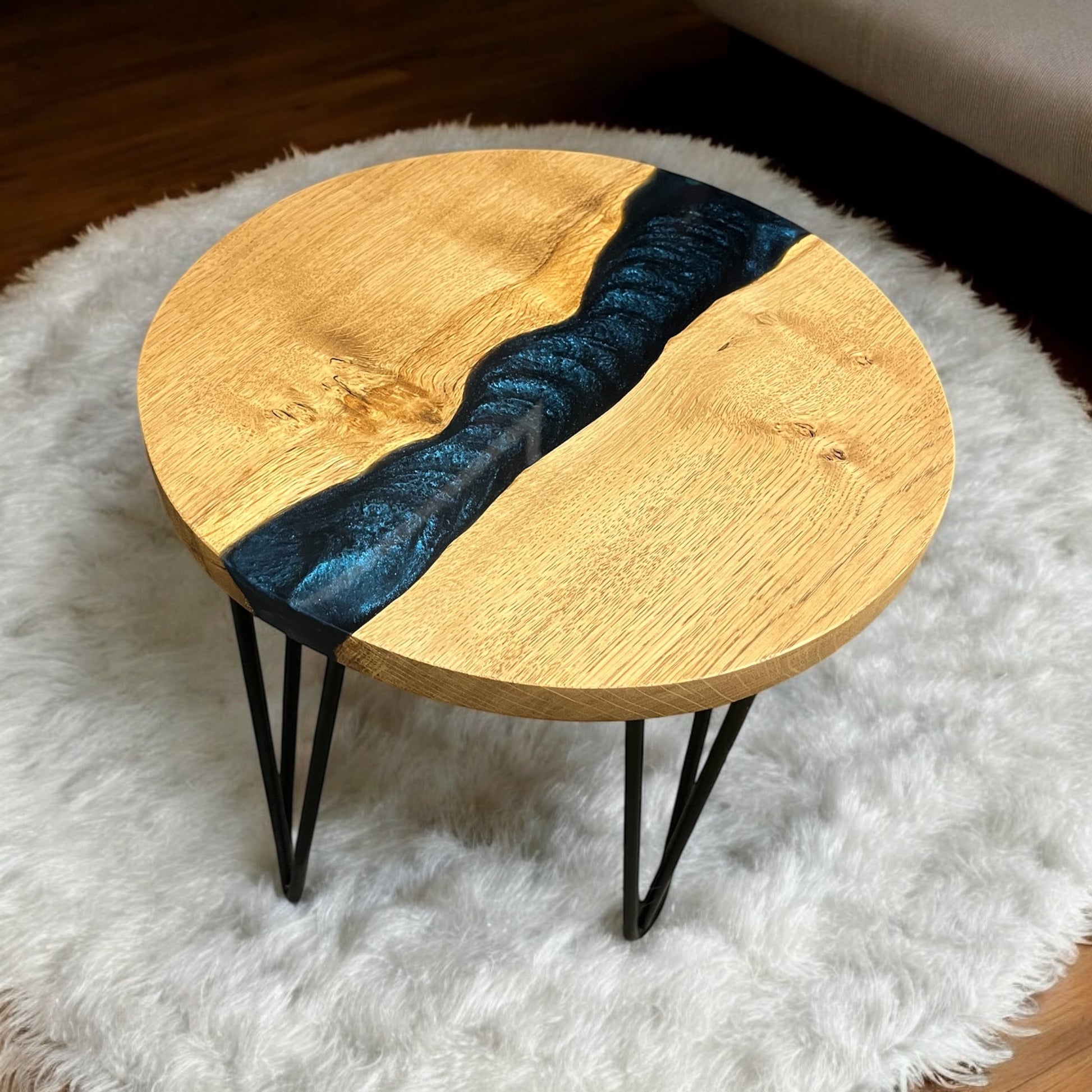 Left-side perspective of the Astral Blue end table, where the resin's cosmic tones contrast beautifully with the natural oak grain.